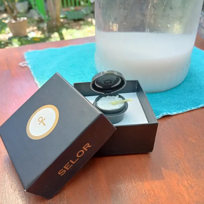 Open SELOR crystal box beside a jar of ORMUS water